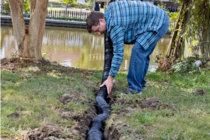 young-homeowner-deals-with-drainage-issues-in-his-backyard